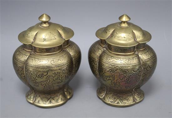 A pair of Chinese brass vases and covers, decorated with figures, cast seal marks to the bases, height 18cm